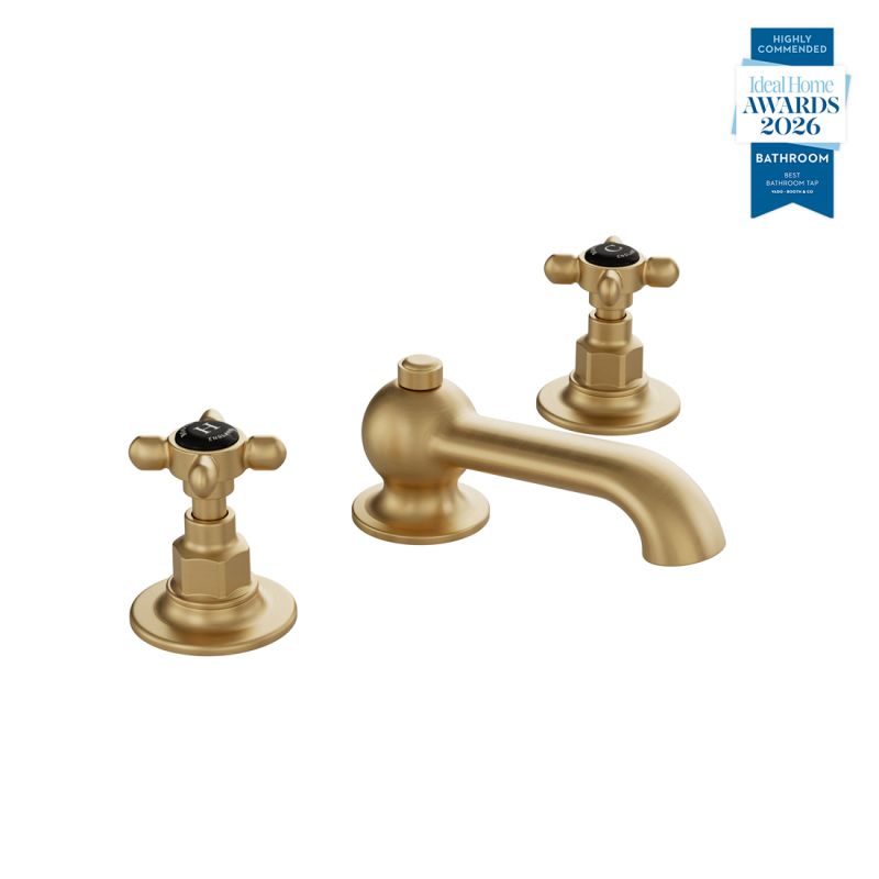 Booth & Co. Axbridge basin mixer tap with a pop up basin waste and cross handles, finished in brushed brass with black ceramic accents.