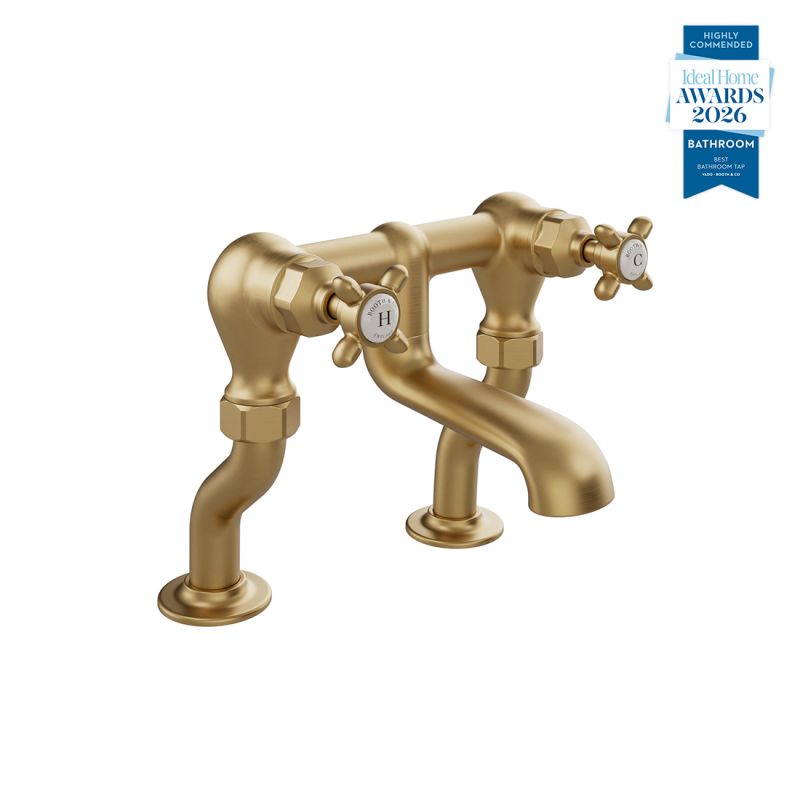 Booth & Co. Axbridge bath filler tap with cross handles, finished in brushed brass with crackled off-white ceramic accents.