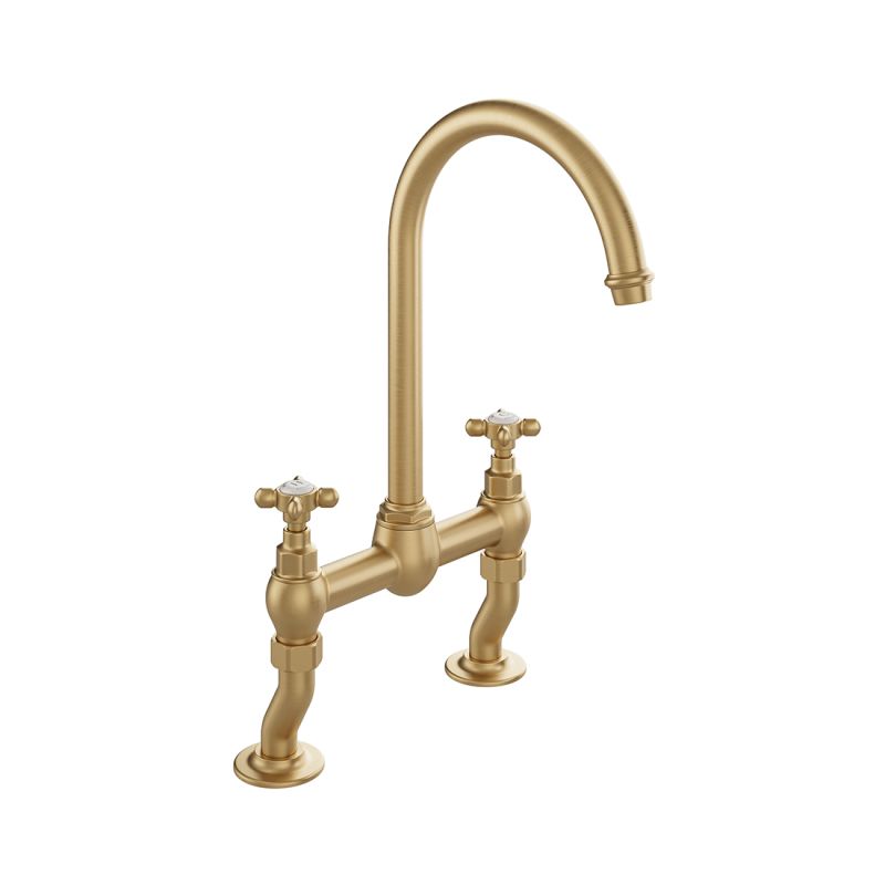 Booth & Co. Axbridge bridge kitchen tap mixer with cross handles, finished in brushed brass with off-white ceramic accents.
