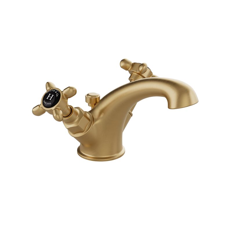 Booth & Co. Axbridge Mono basin mixer tap with a pop up basin waste and cross handles, finished in brushed brass with black ceramic accents.