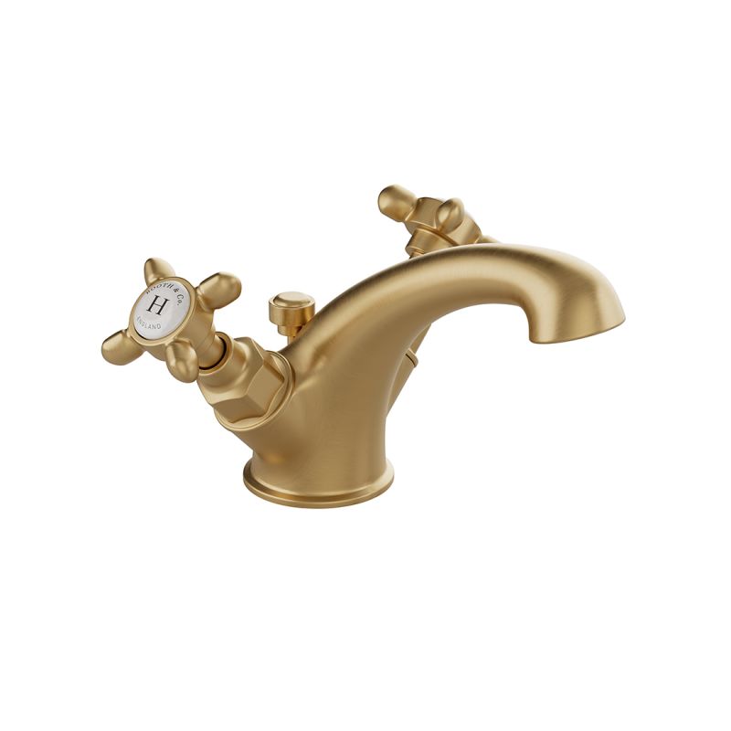 Booth & Co. Axbridge Mono basin mixer tap with a pop up basin waste and cross handles, finished in brushed brass with crackled off-white ceramic accents.