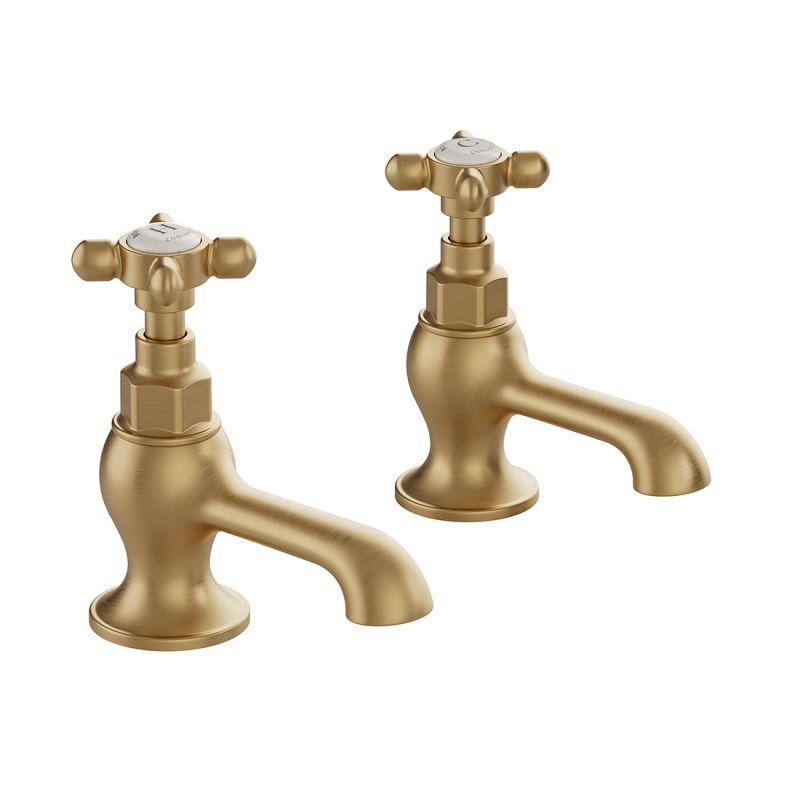 Booth & Co. Axbridge basin pillar taps with cross handles, finished in brushed brass with crackled off-white ceramic accents.