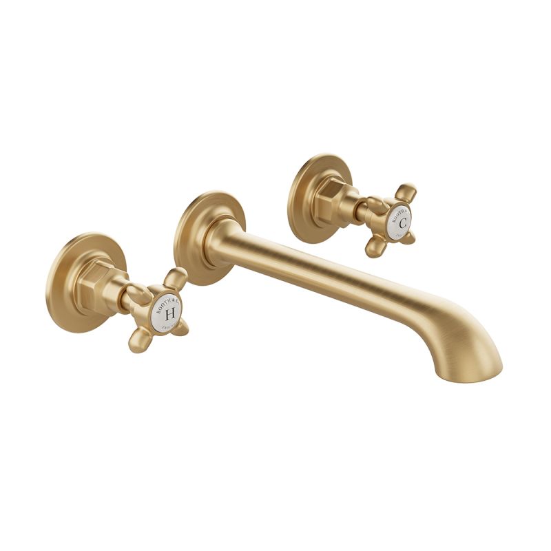 Booth & Co. Axbridge wall mounted basin mixer tap with cross handles, finished in brushed brass with crackled off-white ceramic accents.