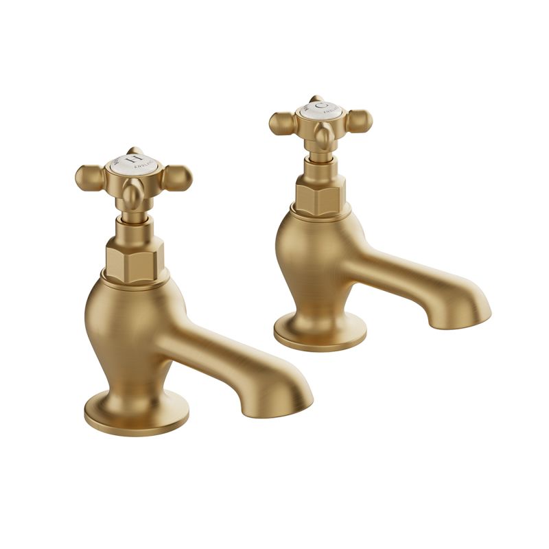 Booth & Co. Axbridge bath pillar taps with cross handles, finished in brushed brass with crackled off-white ceramic accents.