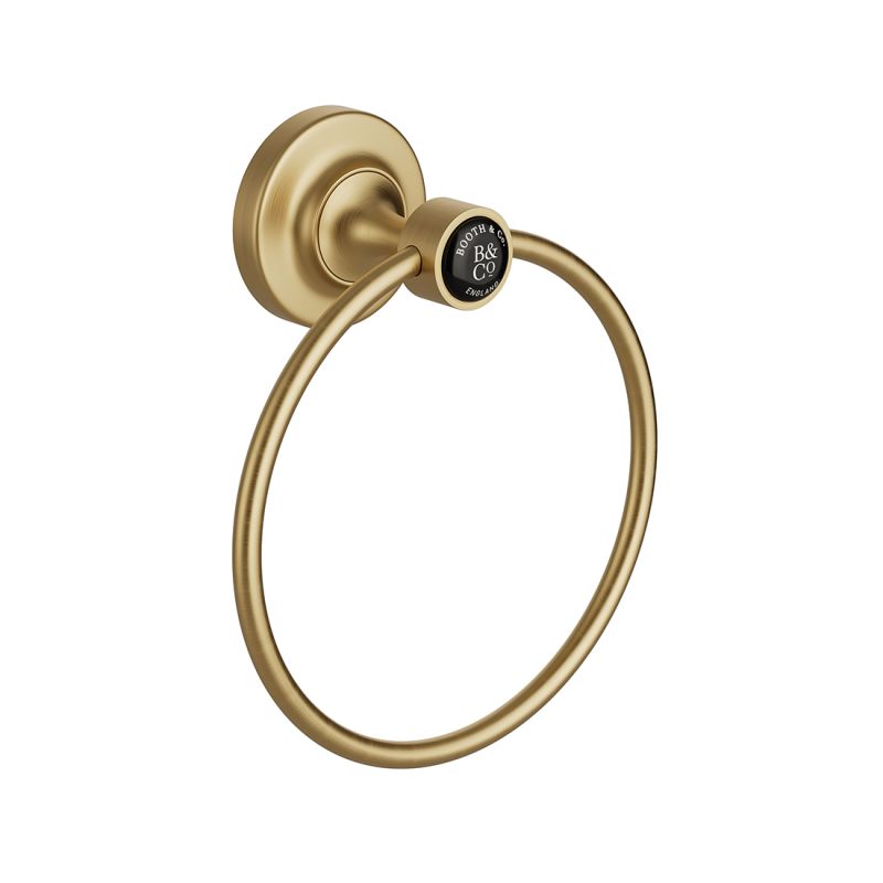 Booth & Co. towel ring, finished in brushed brass with black ceramic accents.