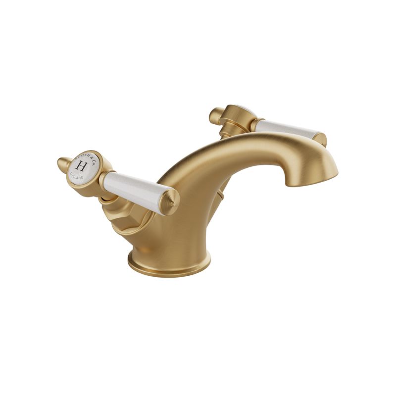 Booth & Co. Axbridge Mono basin mixer tap smooth body with lever handles, finished in brushed brass with crackled off-white ceramic.