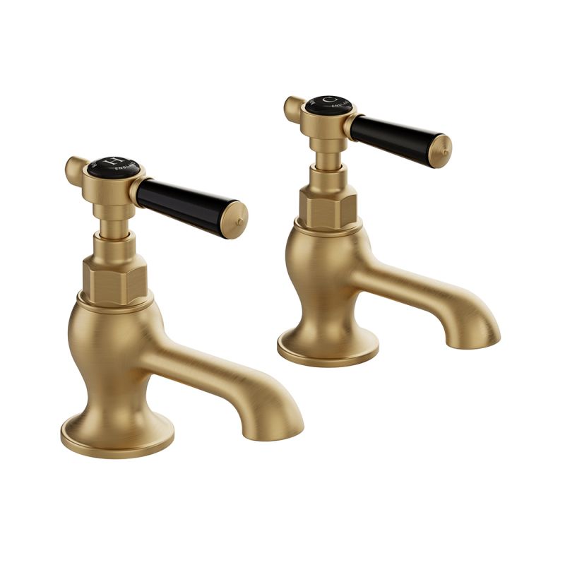 Booth & Co. Axbridge basin pillar taps with lever handles, finished in brushed brass with black ceramic accents.