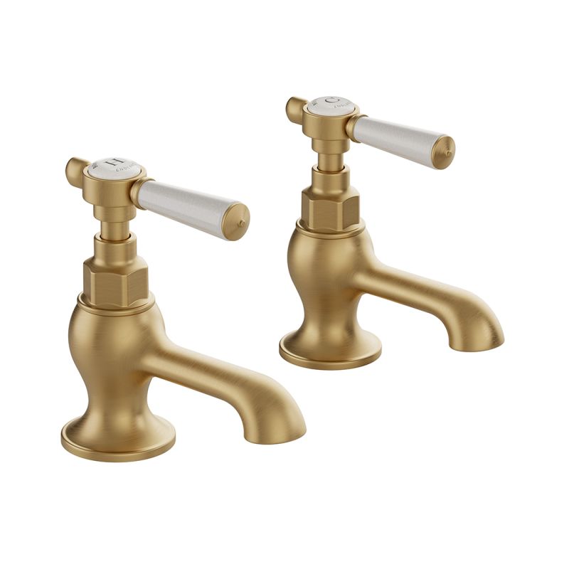 Booth & Co. Axbridge basin pillar taps with lever handles, finished in brushed brass with crackled off-white ceramic accents.