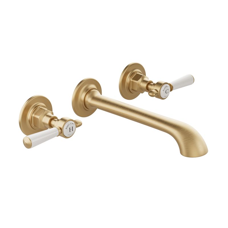 Booth & Co. Axbridge wall mounted basin mixer tap with lever handles, finished in brushed brass with crackled off-white ceramic accents.