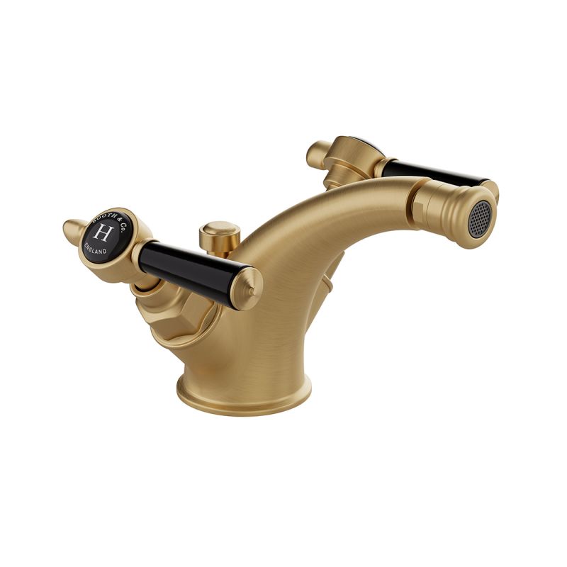 Booth & Co. Axbridge mono bidet mixer with a pop up basin waste and lever handles, finished in brushed brass with crackled off-white ceramic accents.