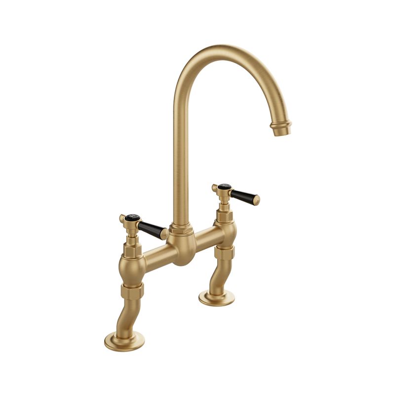 Booth & Co. Axbridge bridge kitchen tap mixer with lever handles, finished in brushed brass with black ceramic accents.